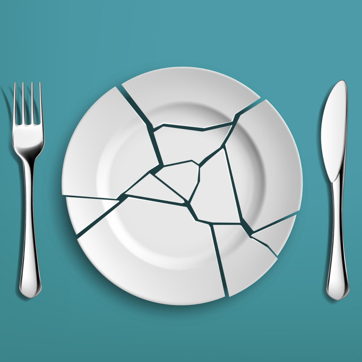 White broken plate with fork and knife on a blue background